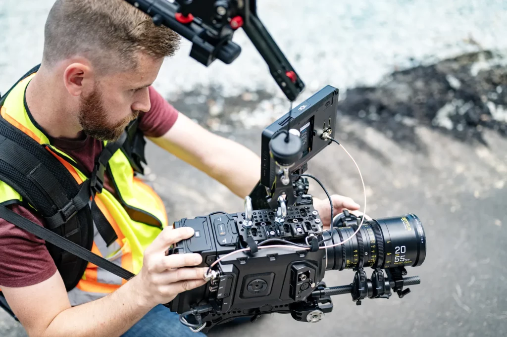 videographer with easyrig holding blackmagic camera on an outdoor shoot