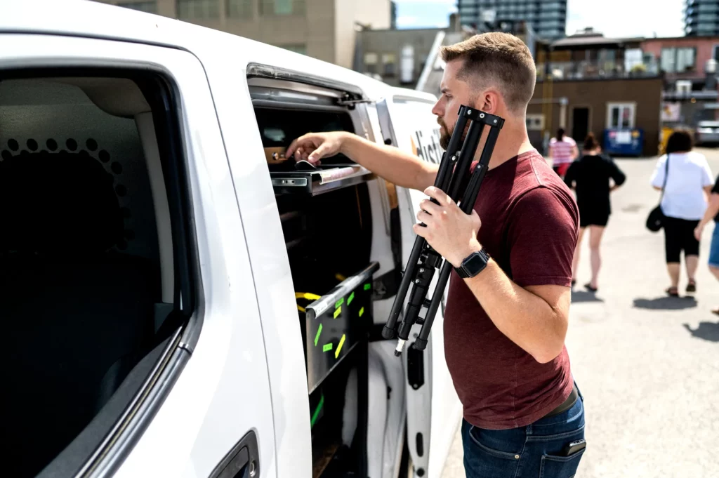 videographer accessing tool chest of production gear outside a business in Kelowna BC